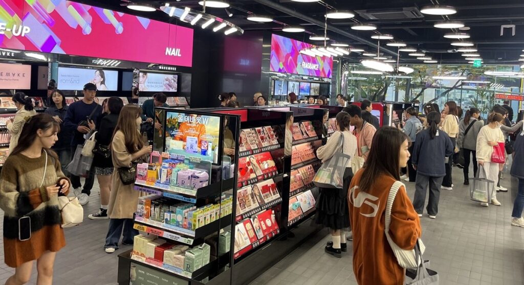 Shopper browsing skincare products inside an Olive Young store in Seoul