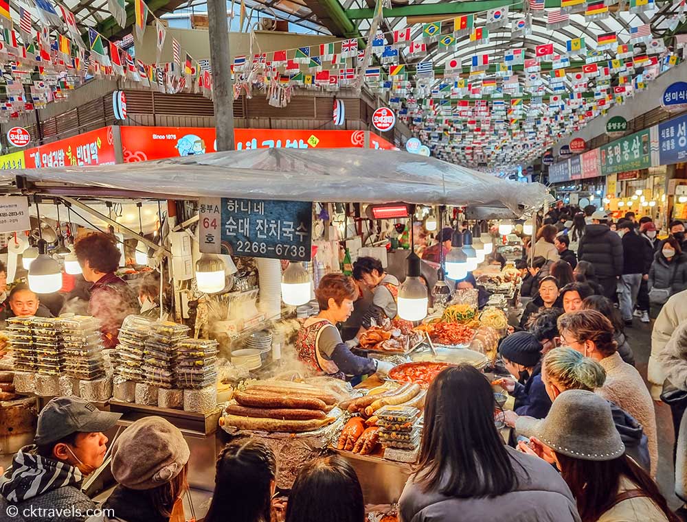Food stalls and diners inside Gwangjang Market in Seoul