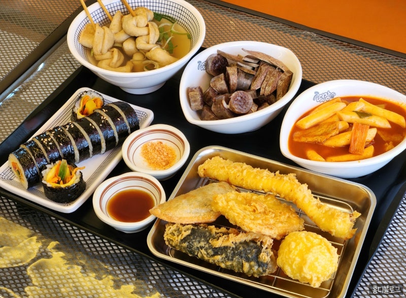 Tteokbokki served with Korean bunsik dishes on a table